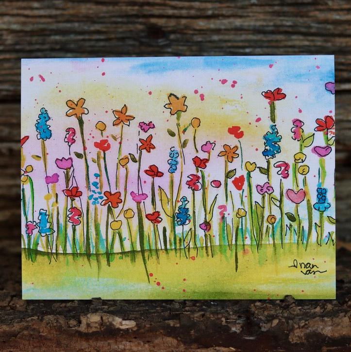 Colorful wildflowers standing in a field card with vibrant sunset