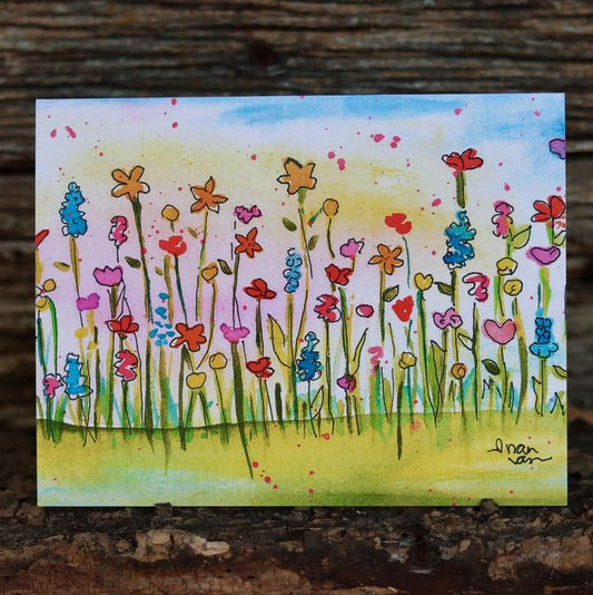 Colorful wildflowers standing in a field card with vibrant sunset