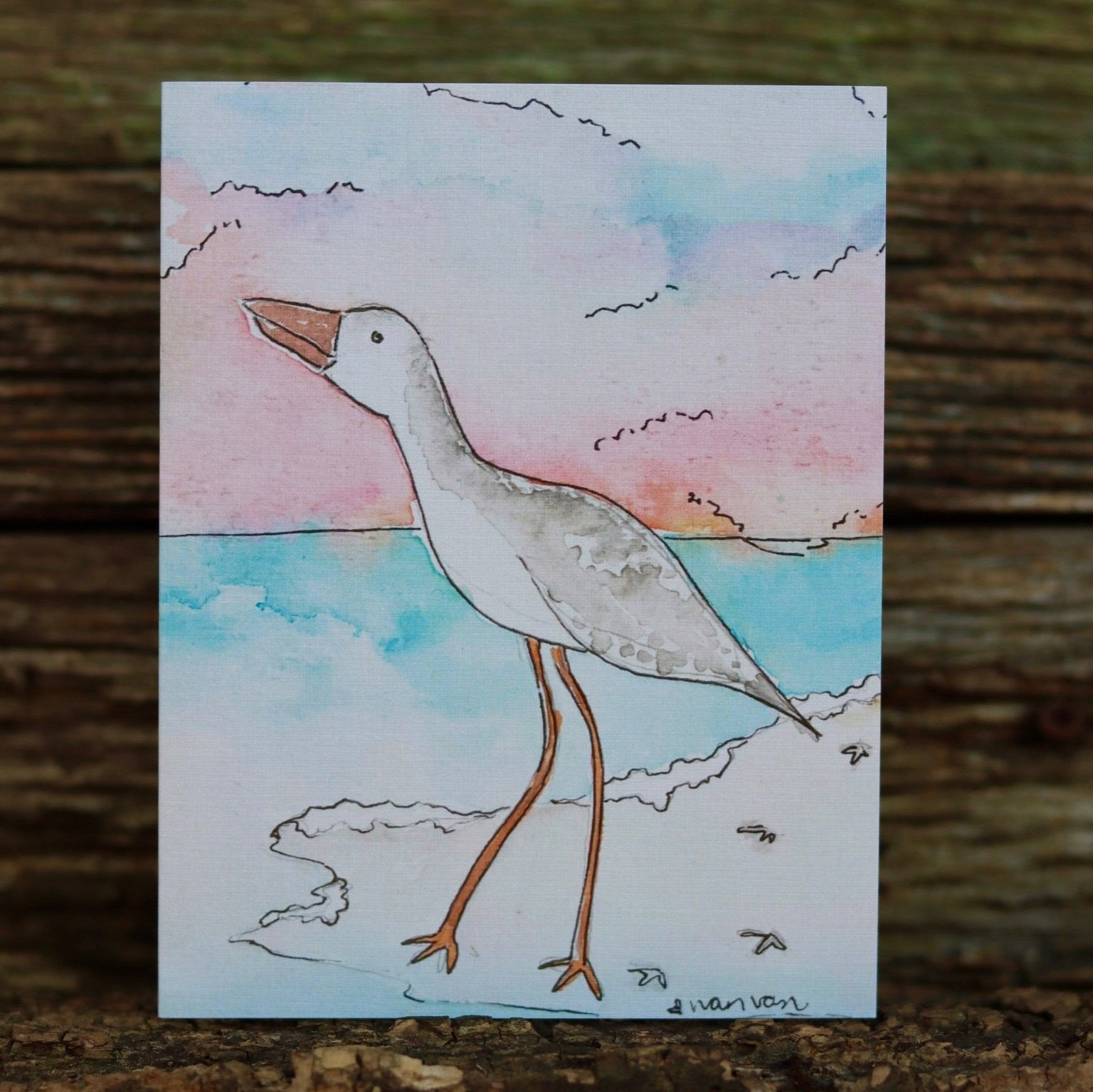 Seaside bird looking at the ocean from the beach card