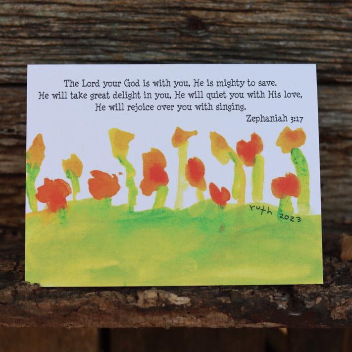 The lord god is with you Zephaniah 3 17 simple flowers in green field greeting card