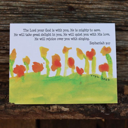 The lord god is with you Zephaniah 3 17 simple flowers in green field greeting card